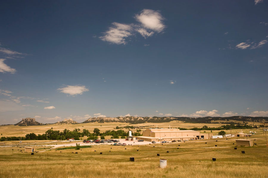An image of the crow butte facility against a field and hills background