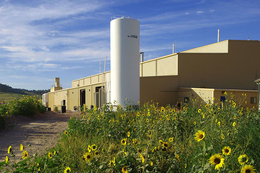 An image of the crow butte facility with sunflowers in the foreground