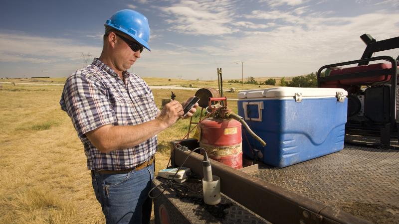 Person in hard hat taking notes