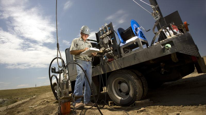 Person taking notes beside bulldozer